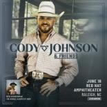 an photo of Cody Johnson he is wearing a white cowboy hat, white button down shirt, jeans and a large belt buckle he is leaning against a black wooden bench
