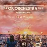 an image showing a sunset sky with the words the OK ORCHESTRA TOUR US SPRING 2022 GAYLE there are 3 people shown at the bottom with their back towards the camera