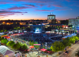 An elevated view of Red Hat Amphitheater during a colorful sunset