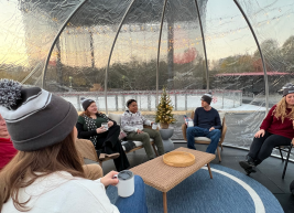 a photo of a group sitting around a coffee table