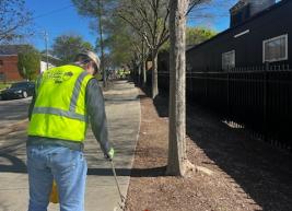 A photo of a volunteer picking up litter 
