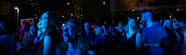 The crowd sings along as a band performs onstage at Red Hat Amphitheater